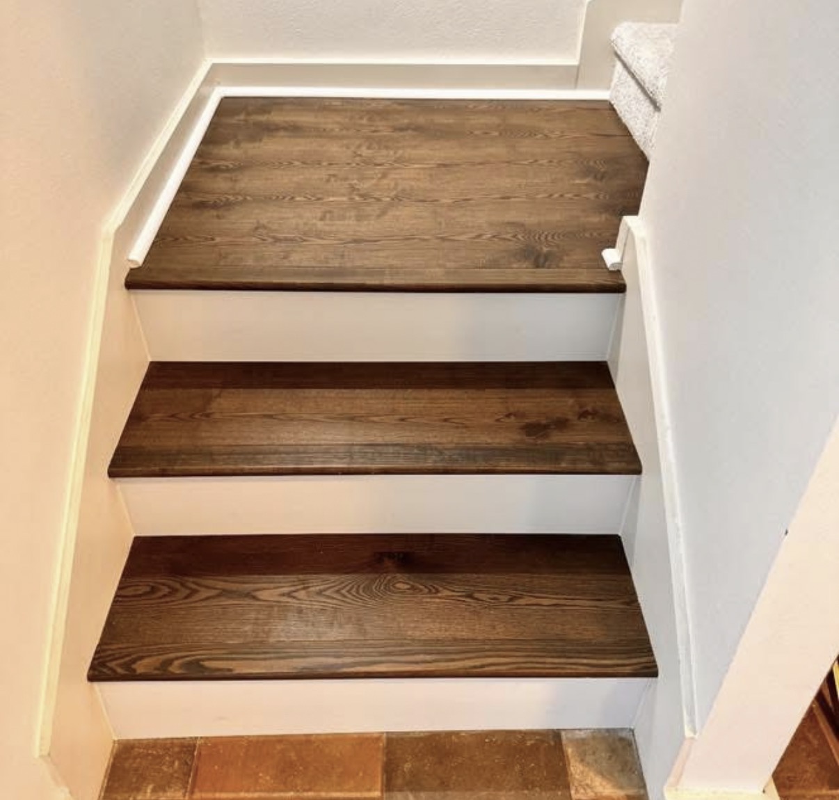 Light hardwood staircase with dining area in Austin